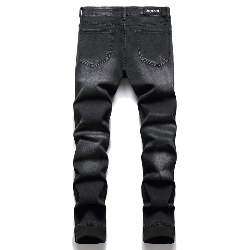 Cracked blue biker jeans: Pleated patch, ripped holes, distressed patchwork. Stretch denim, slim fit for streetwear style.