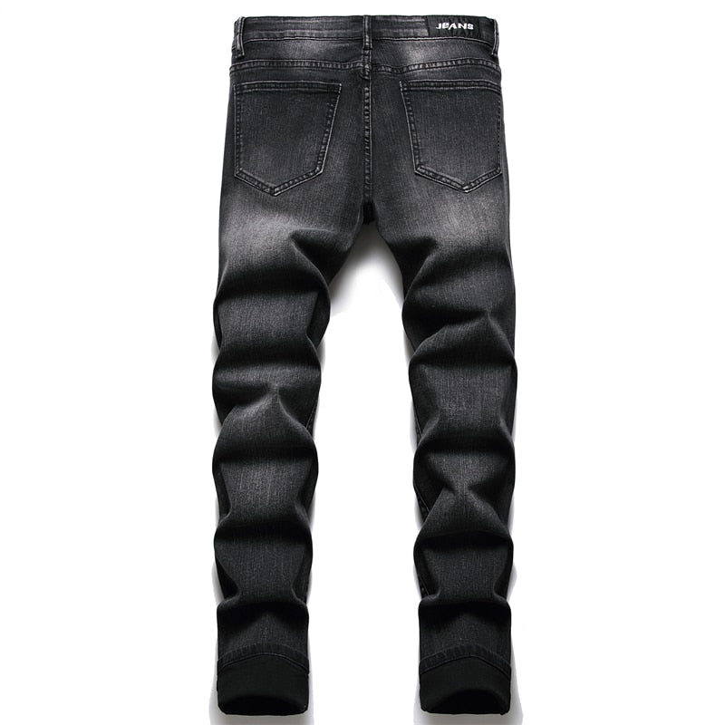 Cracked blue biker jeans: Pleated patch, ripped holes, distressed patchwork. Stretch denim, slim fit for streetwear style.