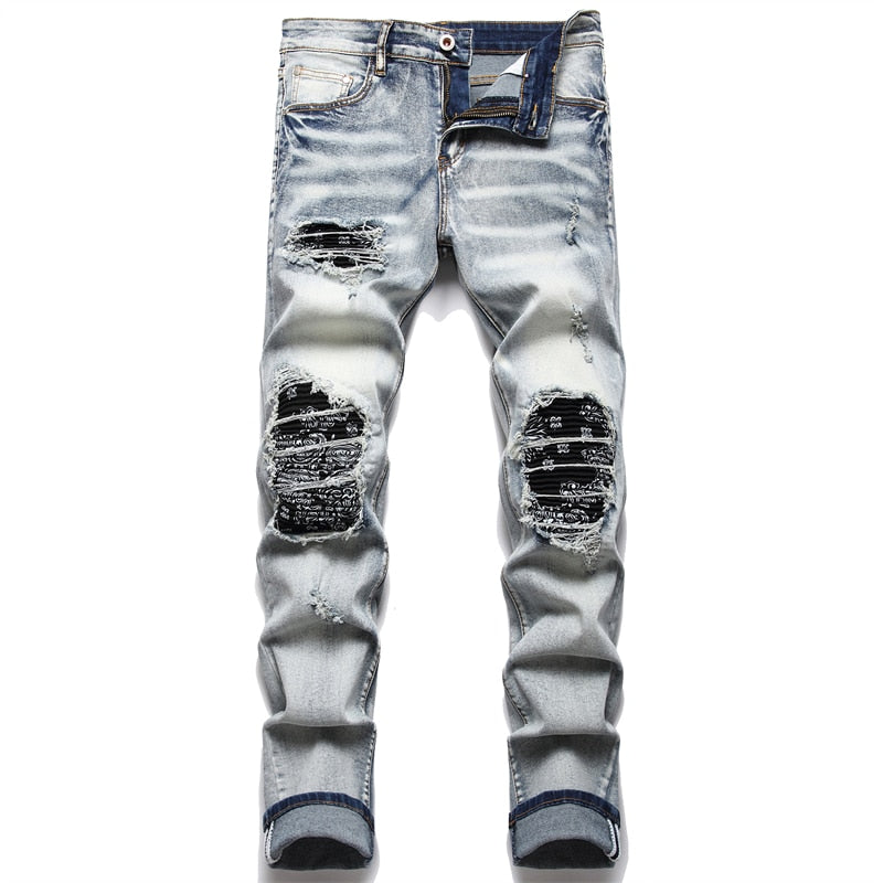 Cracked blue biker jeans: Pleated patch, ripped holes, distressed patchwork. Stretch denim, slim fit for streetwear style.